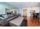 Open living area with sectional sofa and view of dining area and kitchen at 2522 Pine Ridge S Way # A2, Palm Harbor, FL 34684