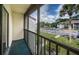 Relaxing screened balcony overlooking the parking lot and green space at 2522 Pine Ridge S Way # A2, Palm Harbor, FL 34684