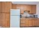 Small kitchen with wood cabinets and appliances at 2522 Pine Ridge S Way # A2, Palm Harbor, FL 34684