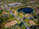 Aerial view of community near a main road and lake at 2522 Pine Ridge S Way # A2, Palm Harbor, FL 34684