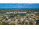 Aerial view of community featuring lake, pool, and buildings at 2522 Pine Ridge S Way # A2, Palm Harbor, FL 34684