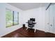 Bright home office features wood floors, built-in mirrored closet and window at 2522 Pine Ridge S Way # A2, Palm Harbor, FL 34684