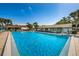 Inviting community pool with ample deck space at 2522 Pine Ridge S Way # A2, Palm Harbor, FL 34684