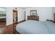 Primary bedroom with wood flooring and ensuite bathroom access at 2522 Pine Ridge S Way # A2, Palm Harbor, FL 34684