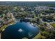 Aerial view of community with lake and buildings at 2522 Pine Ridge S Way # A2, Palm Harbor, FL 34684