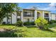 Two-story condo building with lush landscaping at 2522 Pine Ridge S Way # A2, Palm Harbor, FL 34684
