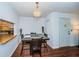 Dining area with table and chairs, and view to kitchen at 2522 Pine Ridge S Way # A2, Palm Harbor, FL 34684