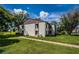 Exterior view of the condo building showcasing landscaping and architecture at 2522 Pine Ridge S Way # A2, Palm Harbor, FL 34684