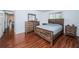 Primary bedroom with wood flooring and ensuite bathroom access at 2522 Pine Ridge S Way # A2, Palm Harbor, FL 34684