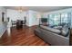 Living room with dark brown leather sofa and dining area at 2522 Pine Ridge S Way # A2, Palm Harbor, FL 34684