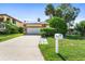 Ranch style home with a two-car garage and a neat lawn at 6316 Spoonbill Dr, New Port Richey, FL 34652