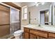 Bathroom with shower, toilet and wood vanity at 6316 Spoonbill Dr, New Port Richey, FL 34652
