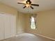 Bright bedroom featuring a ceiling fan and ample closet space at 10409 Meadow Crossing Dr, Tampa, FL 33647