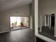 Bright living room with vinyl flooring and sliding glass doors leading to a private patio at 7832 Fox Den Row, Hudson, FL 34667