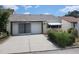 Single-story home with a two-car garage and manicured lawn at 7832 Fox Den Row, Hudson, FL 34667