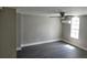 Bedroom with wood-look flooring, large window, and ceiling fan at 7832 Fox Den Row, Hudson, FL 34667