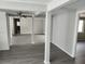 Open concept living area with ceiling fan and gray vinyl flooring at 7832 Fox Den Row, Hudson, FL 34667