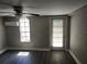 Bedroom with wood-look flooring, window, and door to exterior at 7832 Fox Den Row, Hudson, FL 34667