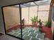Private, fenced courtyard with red mulch and stone accents at 7832 Fox Den Row, Hudson, FL 34667