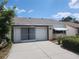 House exterior with a two car garage and landscaping at 7832 Fox Den Row, Hudson, FL 34667