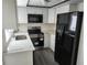Modern kitchen featuring stainless steel appliances and quartz countertops at 7832 Fox Den Row, Hudson, FL 34667