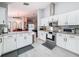Modern kitchen with white cabinets, granite countertops, and stainless steel appliances at 3327 Golden Eagle Dr, Land O Lakes, FL 34639