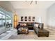 Spacious living room featuring a large sectional sofa and access to a patio at 3327 Golden Eagle Dr, Land O Lakes, FL 34639