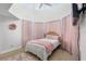 Charming bedroom with light pink accents and a ceiling fan at 13521 Stacey Dr, Hudson, FL 34667
