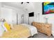 Bright bedroom with yellow bedding and wood dresser at 13521 Stacey Dr, Hudson, FL 34667