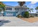 Two-story home with attached garage and palm trees at 13521 Stacey Dr, Hudson, FL 34667