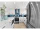 Updated kitchen with stainless steel appliances and a stylish backsplash at 13521 Stacey Dr, Hudson, FL 34667