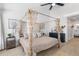 Main bedroom with four-poster bed and ensuite bathroom access at 13521 Stacey Dr, Hudson, FL 34667