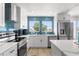 Modern kitchen with stainless steel appliances and white cabinetry at 13521 Stacey Dr, Hudson, FL 34667