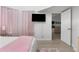 Bedroom with a view into another room and pink accents at 13521 Stacey Dr, Hudson, FL 34667