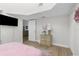 Bright bedroom with wood dresser and view into another room at 13521 Stacey Dr, Hudson, FL 34667