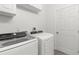 Laundry room with washer, dryer, and built-in cabinets at 13521 Stacey Dr, Hudson, FL 34667