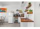 Small galley kitchen with white cabinets and wood countertops at 13521 Stacey Dr, Hudson, FL 34667
