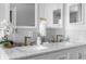 Elegant bathroom vanity with marble countertops and gold fixtures at 13521 Stacey Dr, Hudson, FL 34667
