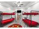 Bedroom with two bunk beds, TV, and nautical rug at 13521 Stacey Dr, Hudson, FL 34667