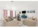 Bright living room with comfy sofas, a large TV, and stylish decor at 13521 Stacey Dr, Hudson, FL 34667