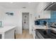 Clean and functional kitchen with white cabinets and pantry access at 13521 Stacey Dr, Hudson, FL 34667
