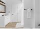 Clean bathroom with white vanity, shower, and wood-look floors at 13521 Stacey Dr, Hudson, FL 34667