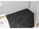 Dark marble tile shower floor at 13521 Stacey Dr, Hudson, FL 34667