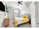 Bedroom with yellow bedding, dresser, and TV at 13521 Stacey Dr, Hudson, FL 34667