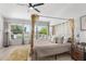 Bright main bedroom with a four-poster bed and water views at 13521 Stacey Dr, Hudson, FL 34667