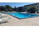Community pool with lounge chairs and patio area at 5123 Topaz Ln # 105, New Port Richey, FL 34652