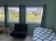 Bedroom with window seating and view of lush landscaping at 5123 Topaz Ln # 105, New Port Richey, FL 34652