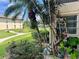 Landscaped area with tropical plants and walkway at 5123 Topaz Ln # 105, New Port Richey, FL 34652