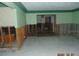 Room with exposed wall studs and damaged flooring at 2044 Montana Ne Ave, St Petersburg, FL 33703