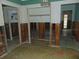 Room with exposed wall studs and damaged flooring at 2044 Montana Ne Ave, St Petersburg, FL 33703